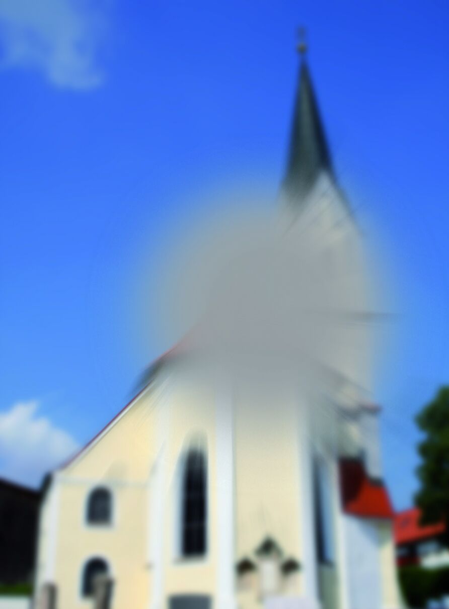 Sehbehindertensonntags - Blick auf eine Kirche. In der Mitte des Bildes, ein grauer Fleck.