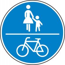 Straßenverkehrsschild für den gemeinsame Geh- und Radweg mit Zeichen 240 StVO / Blaues rundes Schild mit einem waagerechten Streifen oberhalb ein Piktogramm für zu Fuß Gehende und unten eines mit einem Fahrrad